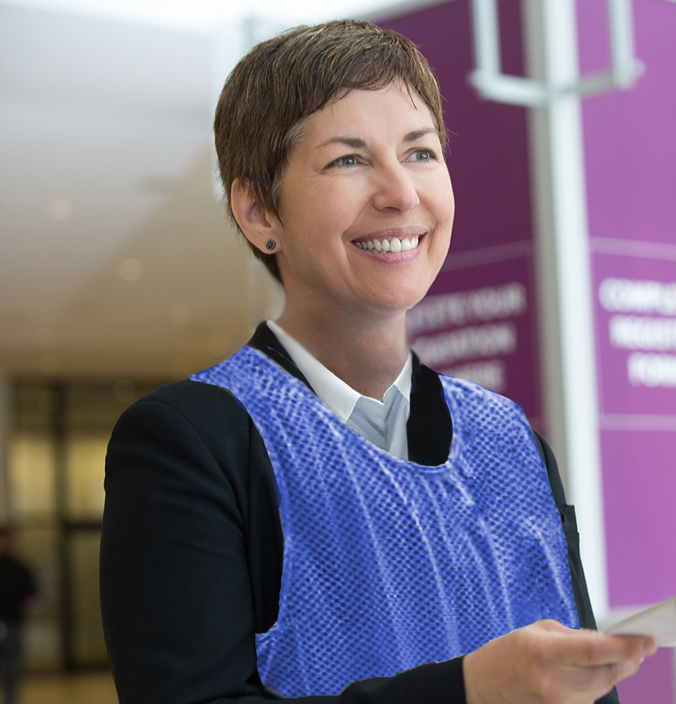 A BBW Staff/COVID Safety Ambassador™ is wearing a blue sports pinnie and maintaining social distancing while smiling.